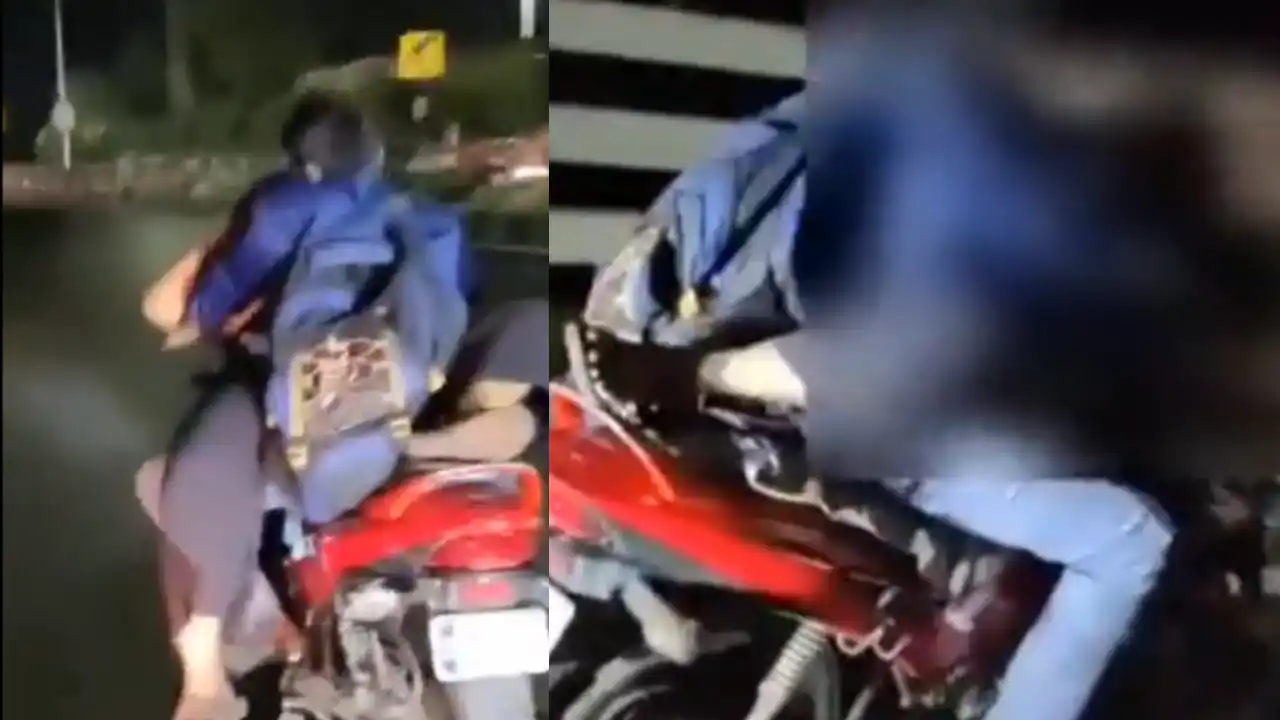 Couple having romance while riding a bike under the influence of alcohol