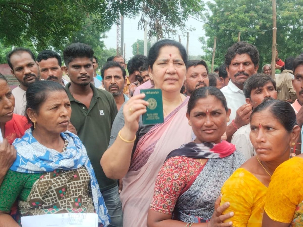 Former Minister Satyavati Rathod standing in queue for urea